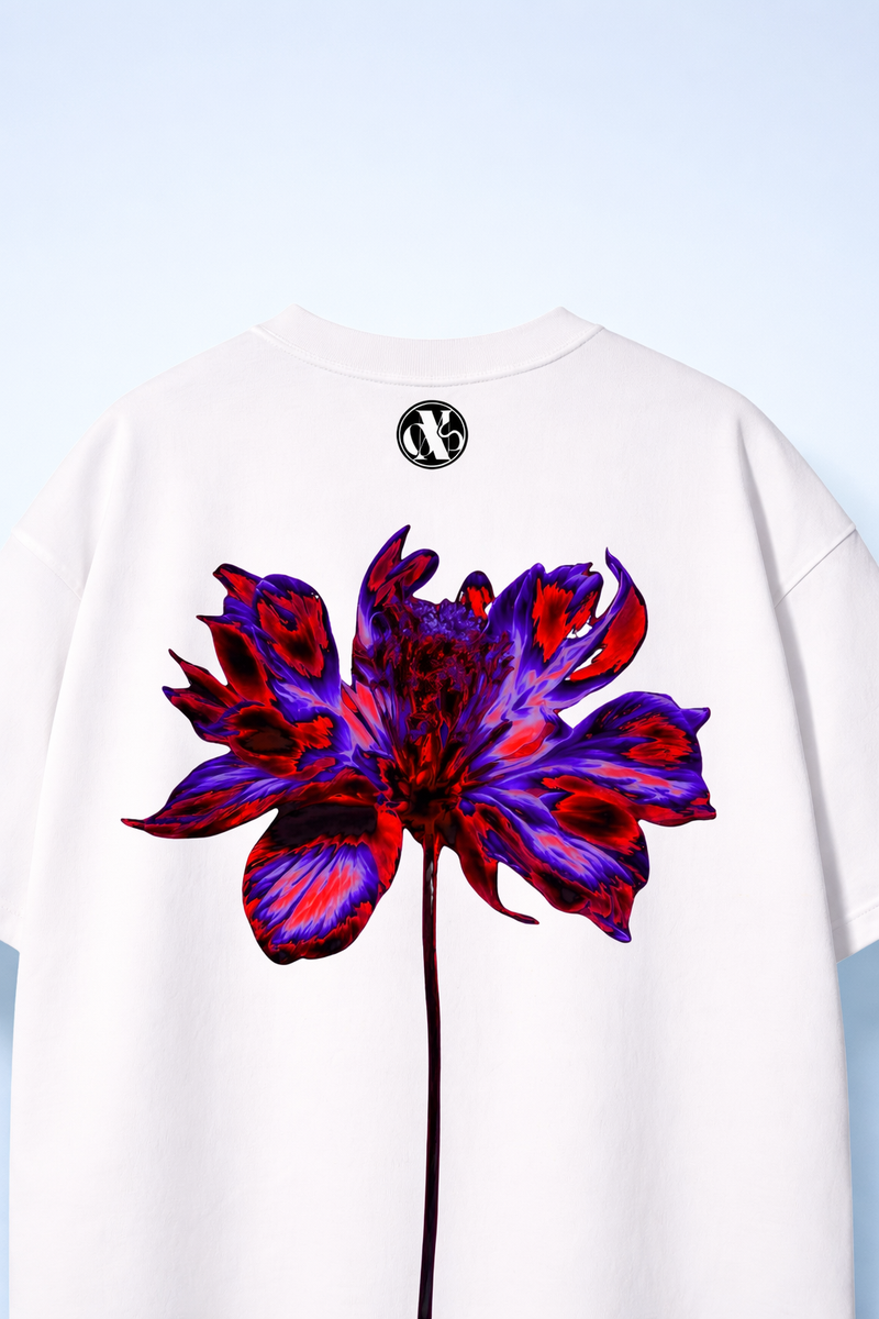White t-shirt with a colorful flower design on the back against a light blue background